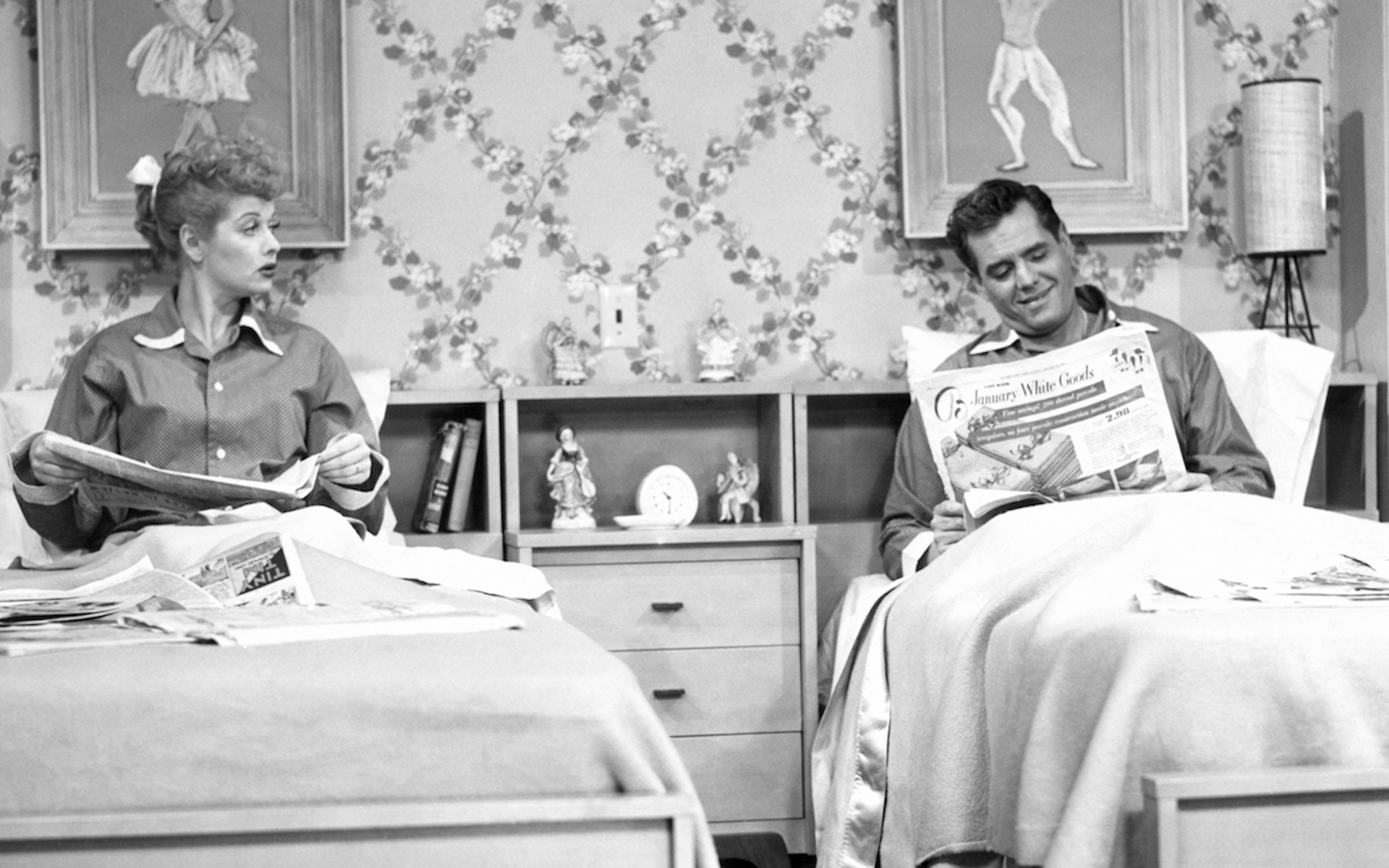 Back and white image of a couple in separate beds sleeping apart